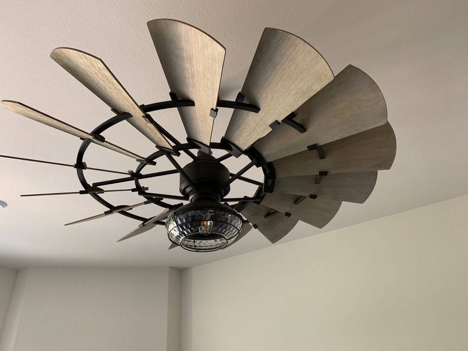 A large multi-blade ceiling fan in a finished residential room