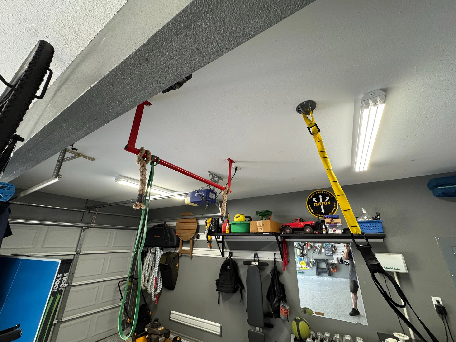 Garage ceiling lighting above an exercise and storage area with the garage door closed