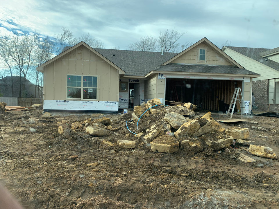 New home under construction with unfinished landscaping