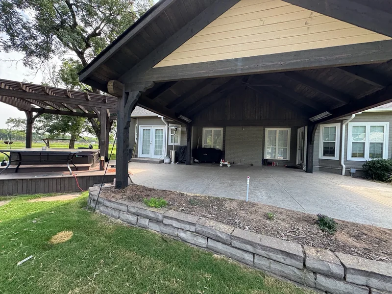 Dark timber gable patio with mounted heaters along the covered area