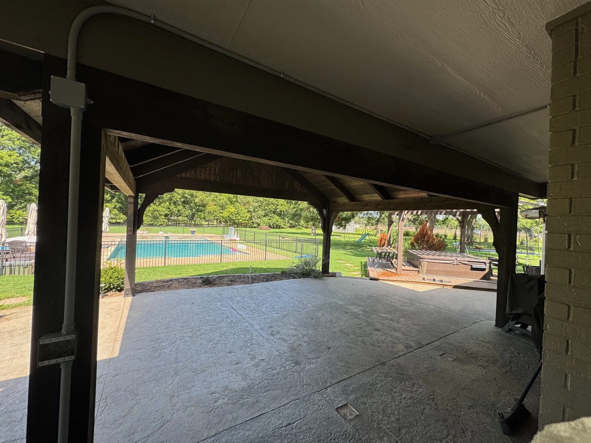 Mounted outdoor heater and electrical conduit along a covered patio structure