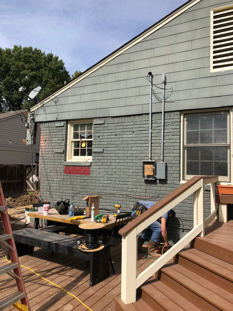 Electrical service equipment on a home with siding beside a wooden deck