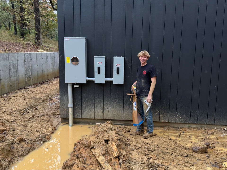Fixed Electric team member alongside an exterior electrical installation